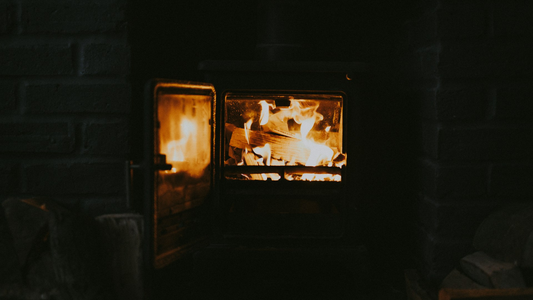 Log burner, open in a dark room. 