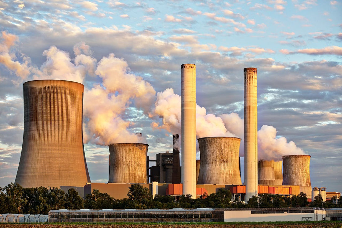 Power station with tall chimneys emitting smoke and smog